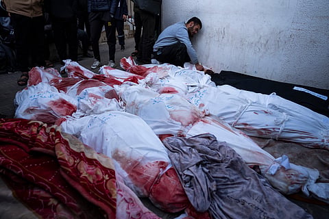 Palestinians mourn relatives killed in the Israeli bombardment of the Gaza Strip at a hospital morgue in Rafah, Monday, Feb. 12, 2024.
