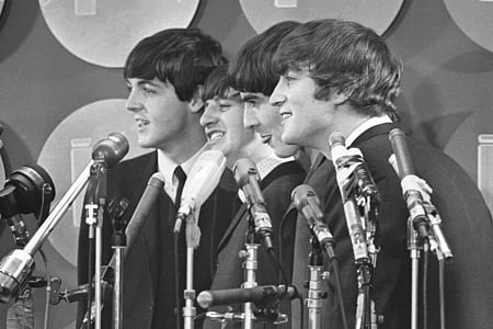 The Beatles address the media in the press room of Kennedy International Airport on their arrival, F
