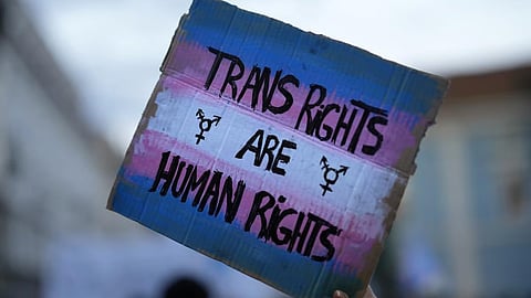 A demonstrator holds up a sign during a march to mark International Transgender Day of Visibility in Lisbon, March 31, 2022.