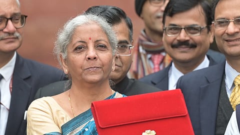 Union Finance Minister Nirmala Sitharaman, holding a folder-case containing the Interim Budget 2024, poses for photos outside the Finance Ministry, in New Delhi. 