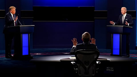 Chris Wallace, of Fox News, center, moderates as President Donald Trump, left, and Democratic candidate former Vice President Joe Biden, speak during the a presidential debate, Sept. 29, 2020, in Cleveland.