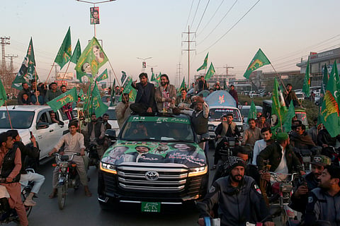 Qari Zahir Shah, center right on vehicle, a winning candidate from Pakistan's former prime minister Nawaz Sharif's party 'Pakistan Muslim League-N, leads rally with his supporters.