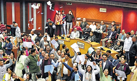 BJP councillors shouting slogans during the special session on the budget at MCD House on Tuesday.  | Parveen Negi
