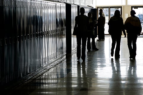 Students walk down a hallway at a high school in Iowa 