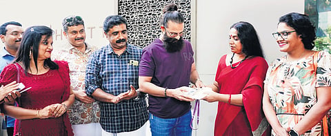 Actor Jolly Chirayath inaugurating the delegate pass distribution of WIFFK 
by giving a pass to actor Jayasurya on Friday.