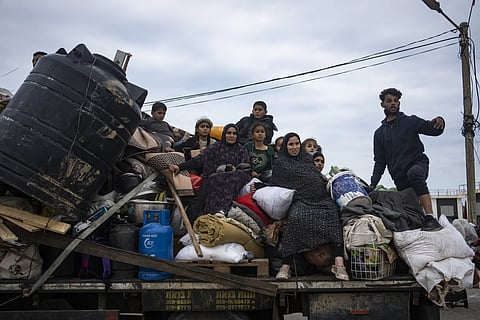 Palestinians arrive in the southern Gaza town of Rafah after fleeing an Israeli ground and air offensive in the nearby city of Khan Younis on Friday, Jan 26, 2024.