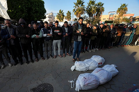Palestinians pray for the relatives killed in the Israeli bombing in the Gaza Strip at Al Aqsa Hospital in Deir al Balah, Gaza Strip, on Saturday, Feb. 17, 2024.