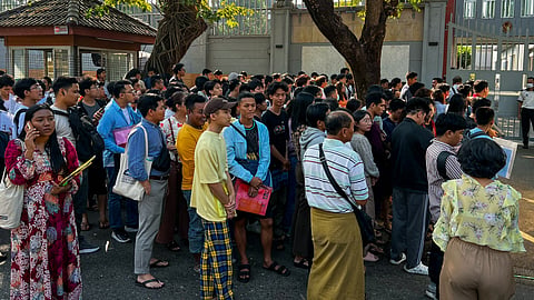 People gather outside the embassy of Thailand to get visas in Yangon on February 16, 2024, after Myanmar's military government said it would impose military service.