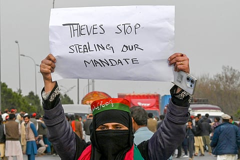 Supporters of Khan's Pakistan Tehreek-e-Insaf (PTI) party block the Peshawar-Islambad highway as they protest against the alleged skewing in Pakistan's national election results in Peshawar on February 12, 2024.