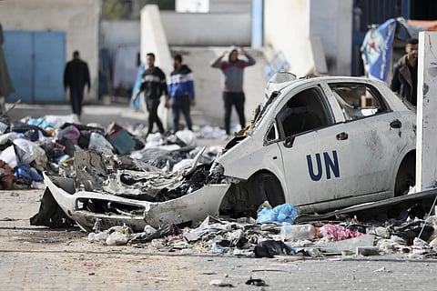 Palestinians walk through the destruction left by the Israeli air and ground offensive on the Gaza Strip in Gaza City, Saturday Feb 10, 2024.