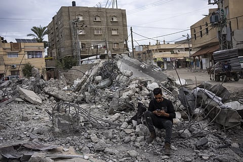 Ibrahim Hasouna, the sole survivor among his family, sits amidst the debris of his bombed home in Rafah, southern Gaza Strip, Tuesday, Feb 13, 2024.
