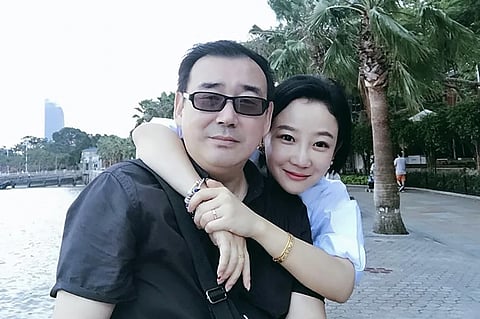 This undated file photo released by Chongyi Feng shows Yang Hengjun, left, and his wife Yuan Xiaoliang. Yang.
