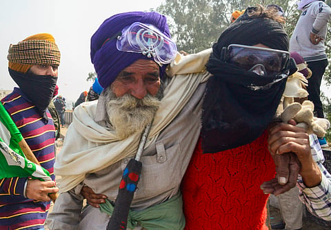 Protesting farmers disperse after a tear gas firing during their 'Delhi Chalo' march, near the Punjab-Haryana Shambhu Border, in Patiala district, Wednesday, Feb. 21, 2024.