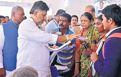 Deputy CM DK Shivakumar receives petitions from people during the ‘Government 
at your Doorstep’ programme at Jnanabharathi on Sunday | Express