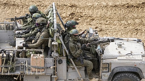 Israeli soldiers drive towards the Gaza Strip, in Southern Israel, Tuesday, Feb 13, 2024. 