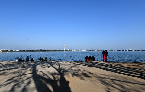 Visitors enjoying the Pleasant weather on the Banks of Hussain sagar lake at Necklace road.