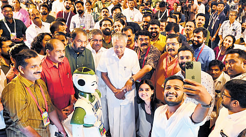 Actor Basil Joseph takes a photograph with Chief Minister Pinarayi Vijayan, LDF ministers Saji Cherian, V Sivankutty and G R Anil at an interactive session with youths in Thiruvananthapuram on Tuesday. Actors Anaswara Rajan and Arjun Ashokan, and an advanced robot Sayabot, built by Asimov Robotics, is also seen, among others | Vincent Pulickal