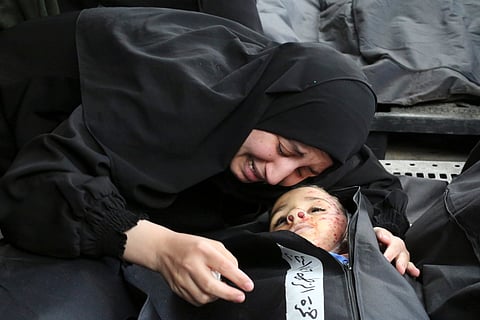A Palestinian woman mourns a child killed in the Israeli bombardment of the Gaza Strip at a morgue in Khan Younis. 