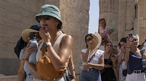 Tourists visit the ancient Acropolis hill during a heat wave in Athens, Greece, on July 21, 2023. 