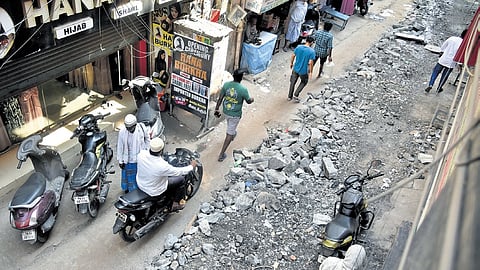 Pedestrians and vehicles moving along  the heavily dug-up Angappa Naicken Street in George Town, one of the busiest streets in the locality 