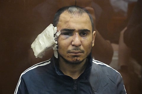 Saidakrami Rachabalizoda, 30, a suspect in the Russia City Hall shooting on Friday sits in a glass cage in the Basmanny District Court in Moscow, Russia, Sunday, March 24, 2024.