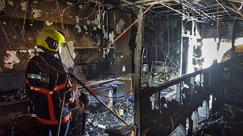Firemen after dousing a fire that broke out at a six-storey corporate park building at suburban Mulund, in Mumbai, Tuesday, March 26, 2024. 