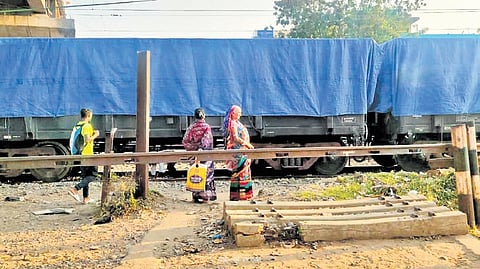 Residents staying near closed level-crossings, wait to cross the track 