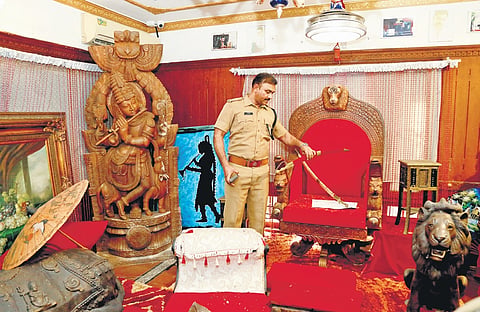 A crime branch official searching the rented house of Monson Mavunkal at Kaloor in Kochi.