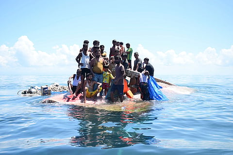An Indonesian search and rescue ship on Thursday located a capsized wooden boat that had been carrying dozens of Rohingya Muslim refugees, and began pulling survivors who had been standing on its hull to safety.