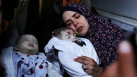 Rania Abu Anza cradles her twins, who were killed in an Israel strike on a house in Rafah, in the southern Gaza Strip, 