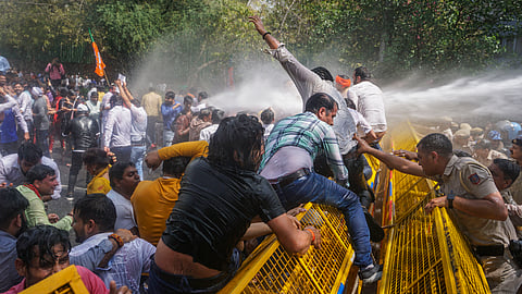 Water cannon being used on BJP workers protesting against Delhi Chief Minister Arvind Kejriwal demanding his resignation after he was recently arrested in connection with an excise policy-linked money-laundering case, in New Delhi, Tuesday, March 26, 2024. 