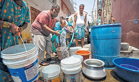 People collect drinking  water from a tanker in  Bengaluru on Monday