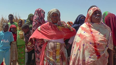 Refugees displaced by the conflict in Sudan gather to receive food staples from aid agencies at a camp in eastern Chad, Tuesday, March 5, 2024.