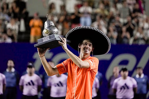 Alex de Minaur of Australia holds up his trophy after beating Casper Ruud of Norway during the final match of the Mexican Open tennis tournament on Saturday, March 2, 2024. 