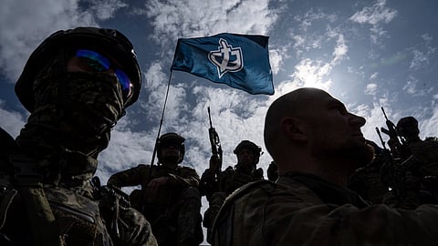 Fighters of Russian Volunteer Corps stand atop on an APC during press conference not far from the Ukraine's border with Russia in Sumy region, Ukraine. 
