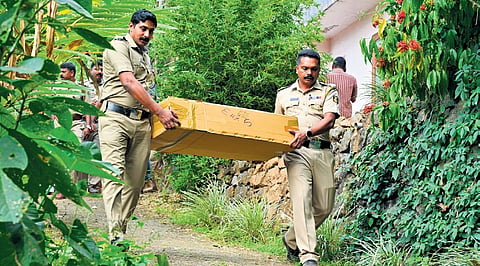 The police taking skeletal remains, believed to be that of Vijayan, to the ambulance on Sunday 