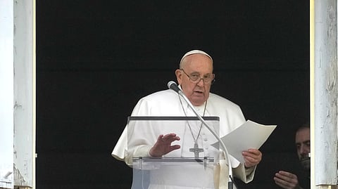Pope Francis reads his message during the Angelus noon prayer from the window of his studio overlooking St. Peter's Square, at the Vatican. 