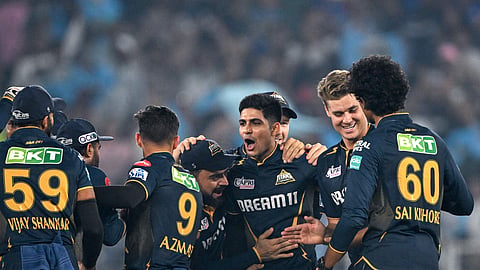 Gujarat Titans' captain Shubman Gill (C) celebrates with teammates after winning the IPL T20 cricket match between Gujarat Titans and Mumbai Indians at the Narendra Modi Stadium in Ahmedabad.
