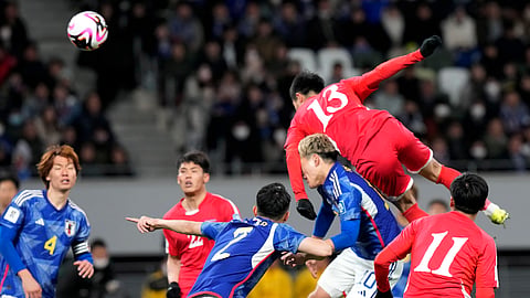 North Korea's Ri Il Song, right top, and Japan's Ritsu Doan, center bottom, compete for the ball during the FIFA World Cup 2026 and AFC Asian Cup 2027 preliminary joint qualification round 2 match. 