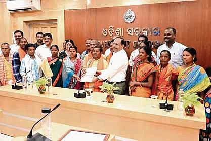 Chief secretary Pradeep Jena presenting habitat rights titles to the tribals 
