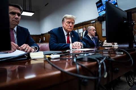 Former President Donald Trump sits in Manhattan criminal court with his legal team ahead of the start of jury selection in New York, Monday, April 15, 2024. 