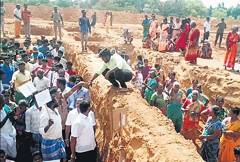 Villagers protested at the construction site of the Vallalar International Centre at Vadalur by standing in the foundation dug for the building 