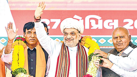 Union Home Minister and BJP leader Amit Shah being felicitated during a public meeting for Lok Sabha elections, in Rajkot district, Gujarat, Saturday, April 27
