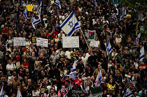 People protest against Israeli Prime Minister Benjamin Netanyahu's government and call for the release of hostages held in the Gaza Strip by the Hamas militant group in Tel Aviv, Israel, Saturday, April 27, 2024.