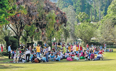 Tourists resting under trees on a hot day at the Ooty Botanical Garden, Nilgiris, on Monday 