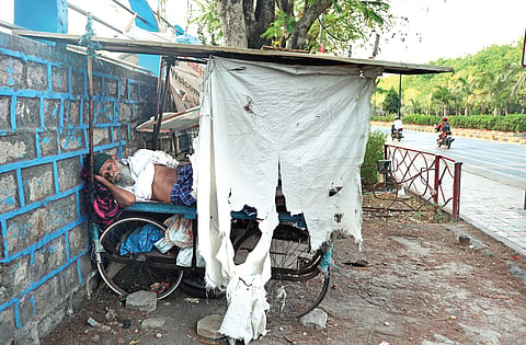 An old man takes a nap on a pushcart as temperatures rose in Hyderabad on Monday. 