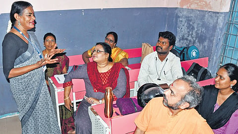 Officer Radha detailing poll work to the other staff at Velachery