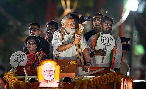 Prime Minister Narendra Modi greets supporters during a roadshow in support of BJP's candidate from South Chennai constituency Tamilisai Soundararajan, ahead of the Lok Sabha election, in Chennai, Tuesday, April 9, 2024. 