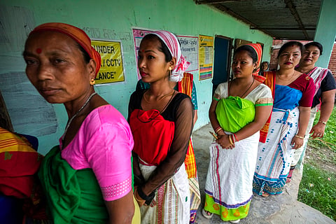 Deori tribal women stand in a queue to cast their vote during the first round of polling of India's national election in Jorhat, Assam.
