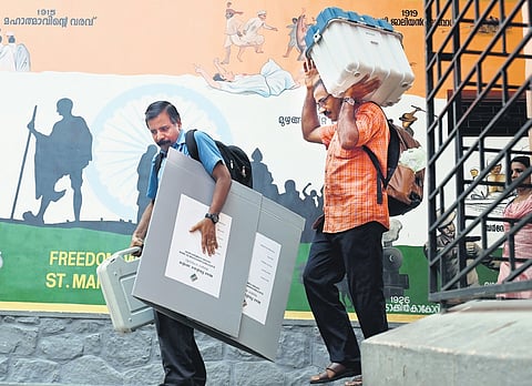 Polling officials carry voting machines and other polling equipment from St Mary’s HSS, Pattom, on Thursday, to their respective polling booths 